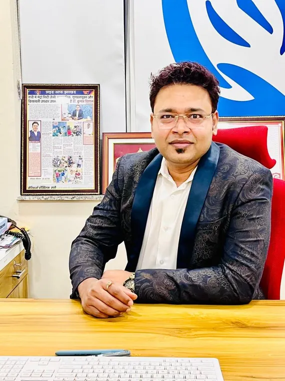 Dr. Kumar Vishal at his desk at Medifirst Hospital with press coverage
